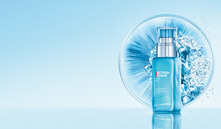 Biotherm Homme bottle placed in front of an icy circular texture on a reflective light blue background