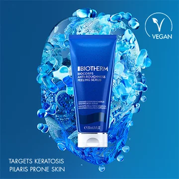 Biotherm Body Refirm Stretch Oil Scrub in blue tube labeled vegan, with background of water droplets and text for keratosis-prone skin.
